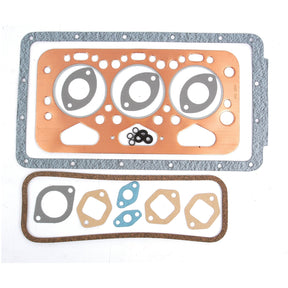 The Top Gasket Set for 3 Cyl. (10/42, 3/45, 3DL, 3/142) by Sparex, Part No. S.52600, features a head gasket with multiple circular cutouts and smaller individual gaskets of various shapes all displayed on a white background.