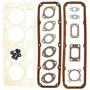 Introducing the Sparex Top Gasket Set (Part No. S.52602) for your 4-cylinder Leyland Engine Models (4/98DT, 38VD, 4/98NT, 4/98TT). This set includes a variety of essential engine gaskets and washers, such as cylinder head gaskets and valve cover gaskets, along with small metal and rubber washers, all neatly arranged on a white surface.