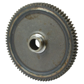 A close-up view of the Transmission Gear PTO - S.65350 by Sparex, featuring splines and a central hole, exhibiting signs of rust and wear.