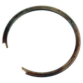A weathered Sparex Transmission Snap Ring (Part No. S.66127), resembling a large circular clip, features a break in its metal surface. The component exhibits signs of rust and wear, akin to an aged part from Main Drive systems or Ford / New Holland machinery.