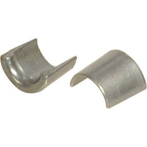 Two small, curved metal components, each with a semi-cylindrical shape, placed side by side on a white background. These Valve Collets (Pair) with Sparex Part No. S.118841 are essential parts for the Sparex Perkins engine family.