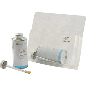 A can of Sparex's Vulcanising Cement 225g (Sparex Part No.S.119681) with an attached brush applicator, placed next to an empty, clear plastic blister packaging labeled Agripak, containing 225g of adhesive.