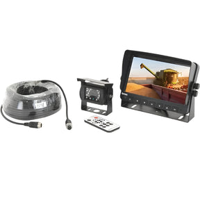 The Sparex Wired Vehicle Camera System (S.166334), featuring a 7'' HD camera, monitor, remote control, coiled cable, and instruction manual, displays a detailed image of a combine harvester on the screen when set up on a surface. Suitable for providing comprehensive information about agricultural machinery.
