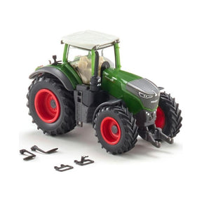 The Fendt - Fendt 1050 Vario (1:87) - X991021116000 by AGCO is a small toy tractor that features a green body, white roof, and red wheels. Several detachable parts are placed nearby, showcasing its detailed craftsmanship by Wiking.