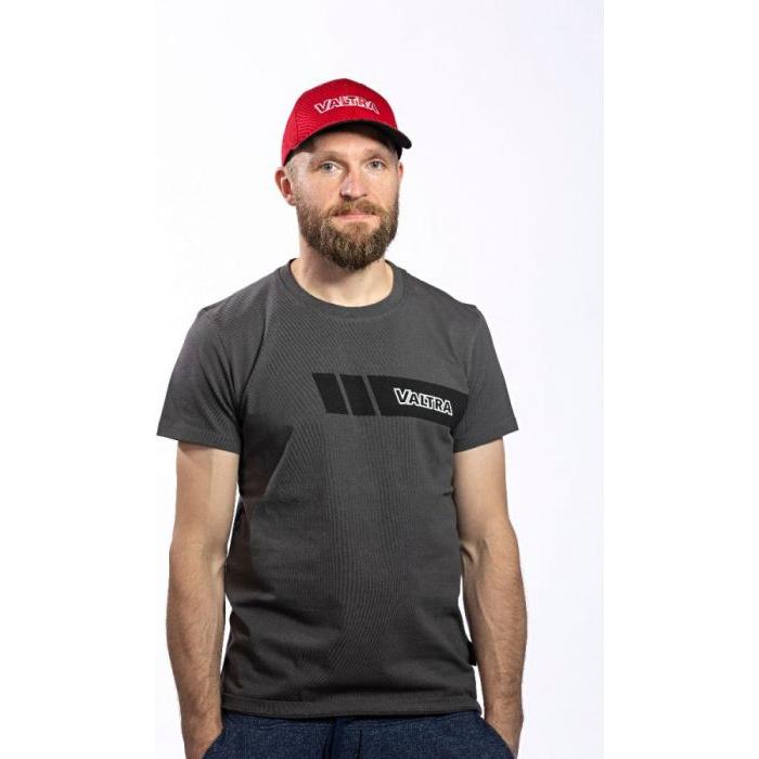 A bearded man is wearing a gray VALTRA t-shirt made of 100% cotton and a red Valtra cap (model: V42501406) by AGCO with a slide buckle, standing against a plain white background.