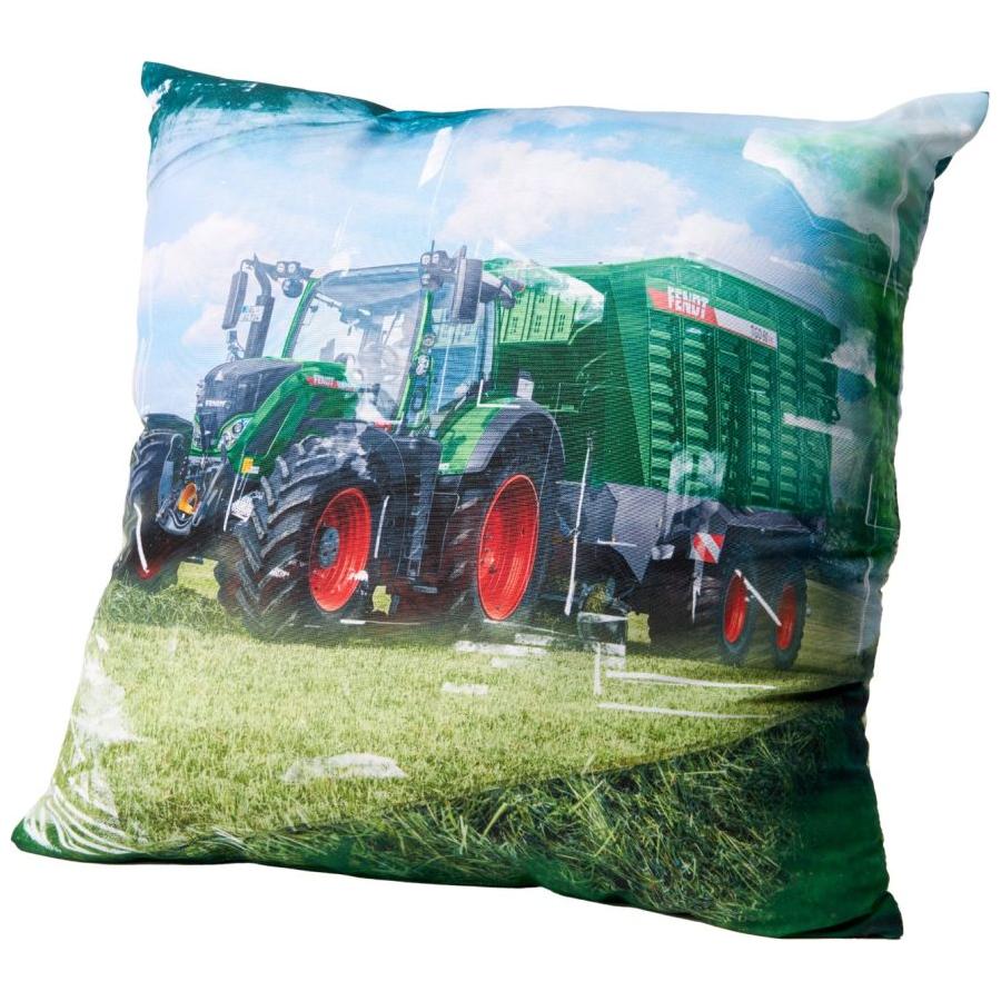The AGCO Fendt - Decorative Cushion: Fendt 724 Vario incl. Fendt Tigo (X991022143000) features a green tractor pulling a green trailer in a grassy field under a partly cloudy sky, making it the perfect decorative cushion for adding character to any space.