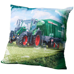 The AGCO Fendt - Decorative Cushion: Fendt 724 Vario incl. Fendt Tigo (X991022143000) features a green tractor pulling a green trailer in a grassy field under a partly cloudy sky, making it the perfect decorative cushion for adding character to any space.